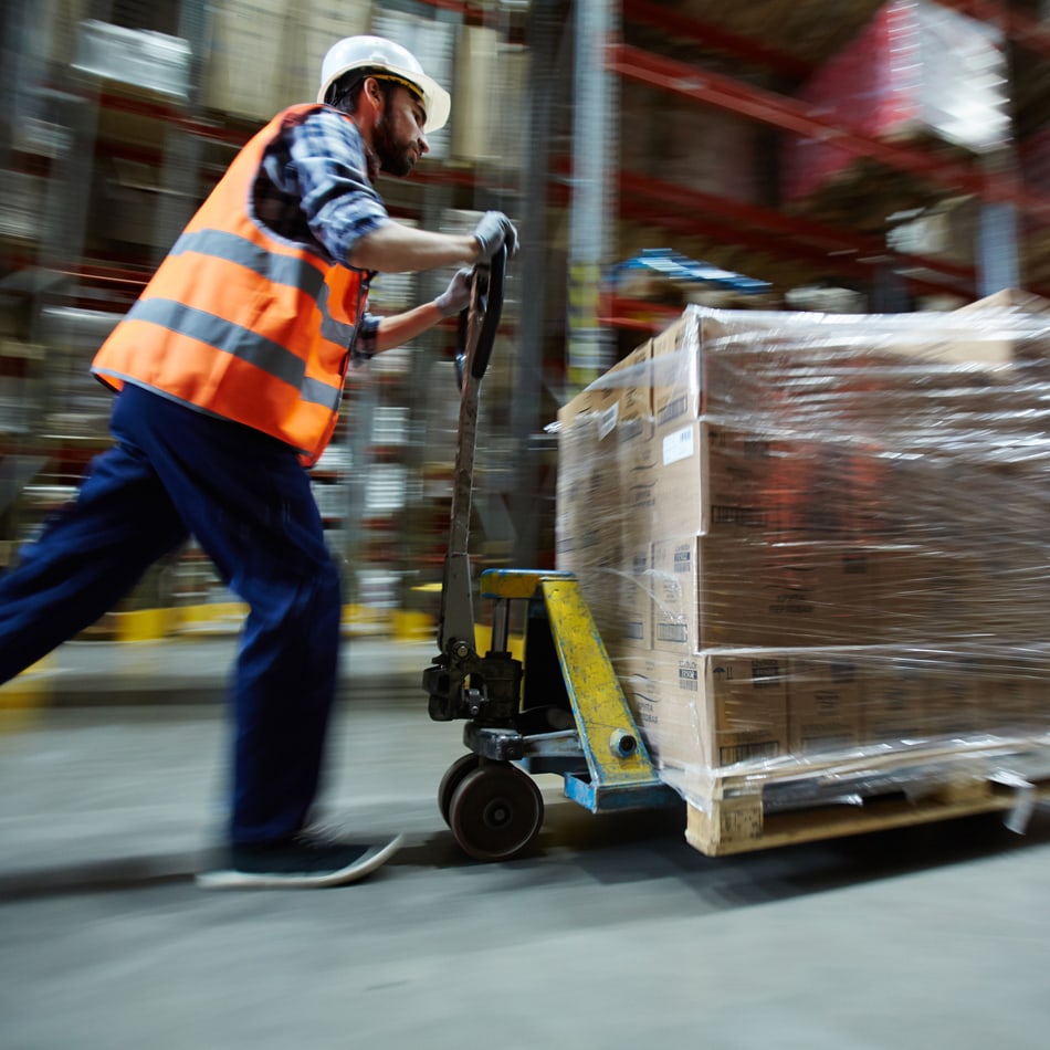 Supply chain professional pushing cart of boxes