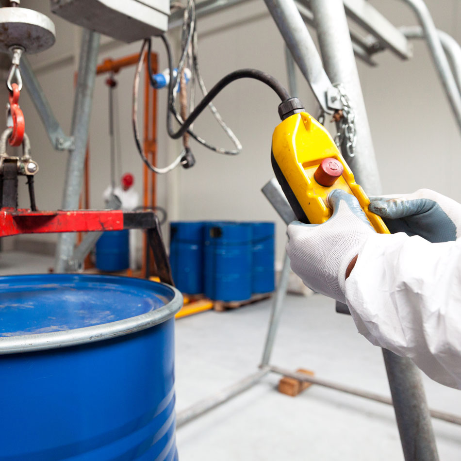 Health and safety professional testing electrical equipment in warehouse