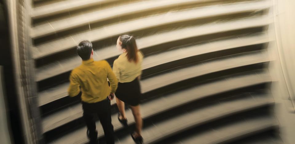 Man and woman walking up stairs