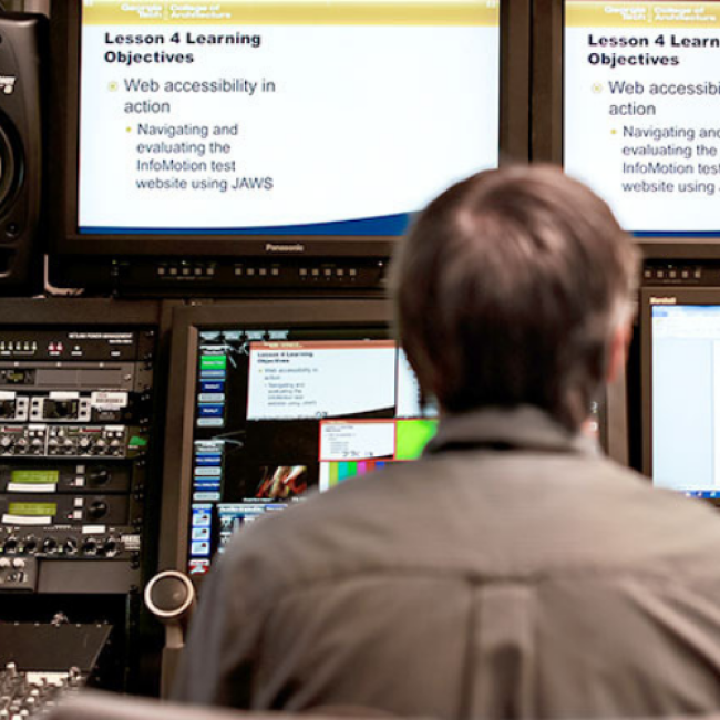 Man sitting in front of controller editing recorded classroom footage