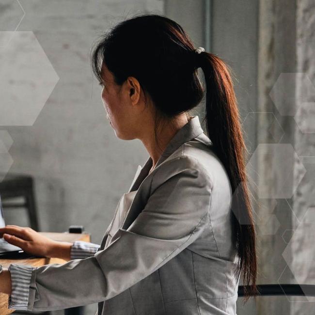 Female university student takes remote learning courses on laptop.